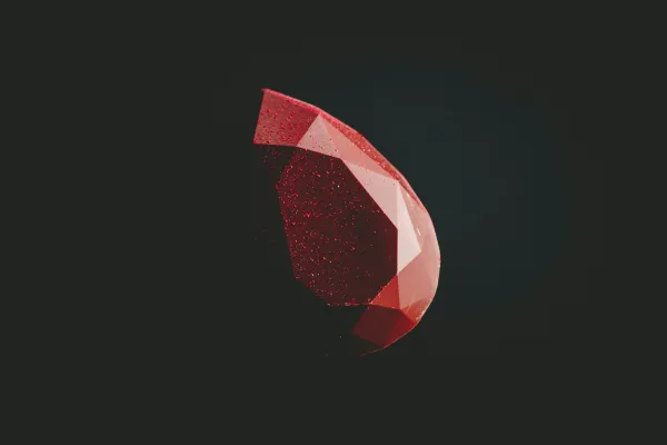 A faceted red ruby against a dark background.