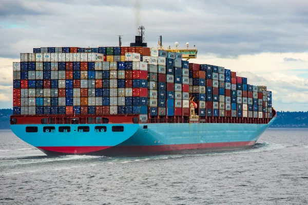 A cargo ship carrying stacked shipping containers.